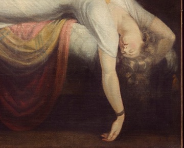 Her limp arm hangs beyond the mattress.