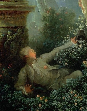 A young man reaches up from the flowers.